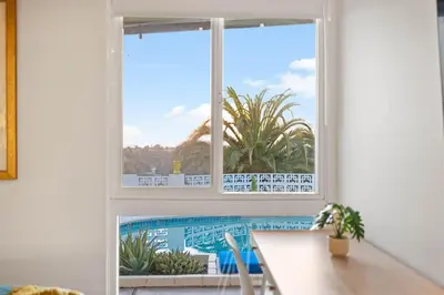 a window in a room with a view of a pool at Luxury Hilltop Stay Pool, Firepit and Views in La Mesa