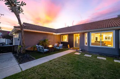 a house with a palm tree in the yard at Modern Oceanside Stay with Yard & Laidback Vibes in Oceanside