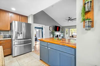 a kitchen with blue cabinets and a stainless steel refrigerator at Modern Oceanside Stay with Yard & Laidback Vibes in Oceanside