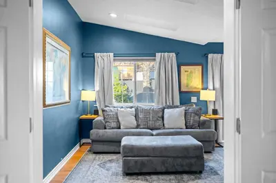 a living room with blue walls and a couch at Modern Oceanside Stay with Yard & Laidback Vibes in Oceanside