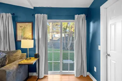 a living room with blue walls and a window at Modern Oceanside Stay with Yard & Laidback Vibes in Oceanside