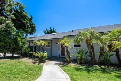 a house with palm trees and a sidewalk at Walk to Beach • La Jolla Home + Free Parking in San Diego