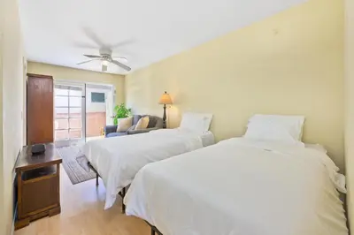 a bedroom with two beds and a couch at Costa del Sol in Newport Beach