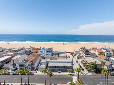 an aerial view of a beach with houses and the ocean at Costa del Sol in Newport Beach