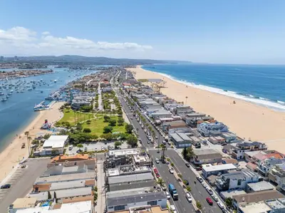 an aerial view of a beach next to the ocean at Costa del Sol in Newport Beach
