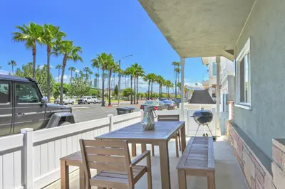 a table and chairs on a balcony with a street at Costa del Sol in Newport Beach