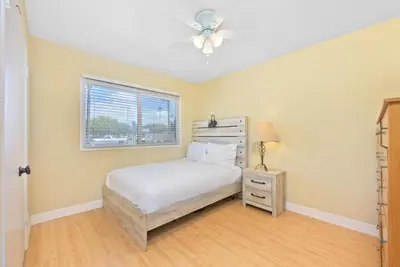 a bedroom with a bed and a window at Costa del Sol in Newport Beach