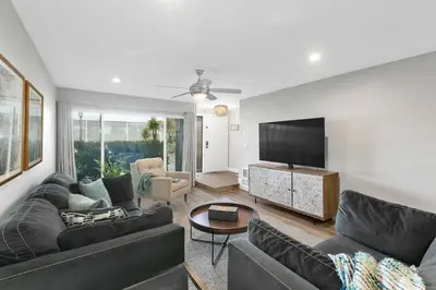 a living room with a couch and a tv at Solana Beach Escape, Beach Access, AC, Pools, Spa, Tennis Courts & Clubhouse Views in Solana Beach