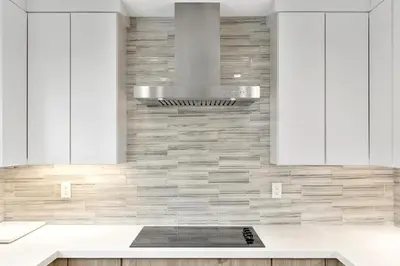 a kitchen with white cabinets and a stove at Solana Beach Escape, Beach Access, AC, Pools, Spa, Tennis Courts & Clubhouse Views in Solana Beach