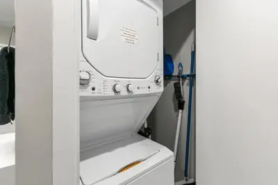 a white washer and dryer in a bathroom at Solana Beach Escape, Beach Access, AC, Pools, Spa, Tennis Courts & Clubhouse Views in Solana Beach