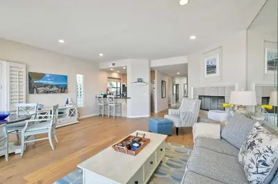 a living room with a couch and a table at Beachfront Sunset in Encinitas