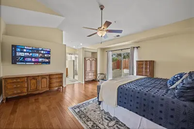 a bedroom with a bed and a flat screen tv at Explore Ramonas Vineyards Tranquil Home with Yard in Ramona