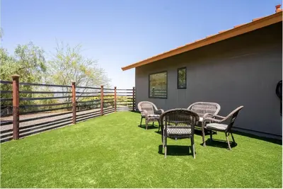 a patio with chairs and a table on the grass at Luxury Mountain Estate Sleeps 11 in Valley Center