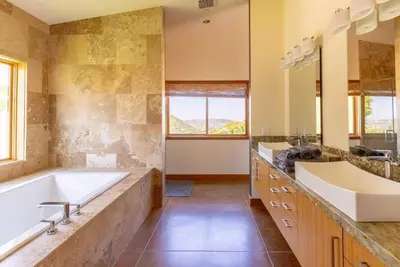 a bathroom with two sinks and a large tub at Luxury Mountain Estate Sleeps 11 in Valley Center