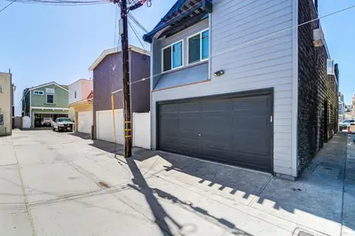 a house with a garage door on a street at Family Beach House Steps From Sand W Oceanview Patio By Beachview Rentals in Newport Beach