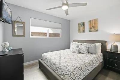 a bedroom with a bed and a ceiling fan at Modern 4Br Vacation Home W Ocean Views And Rooftop Deck By Beachview Rentals in Newport Beach