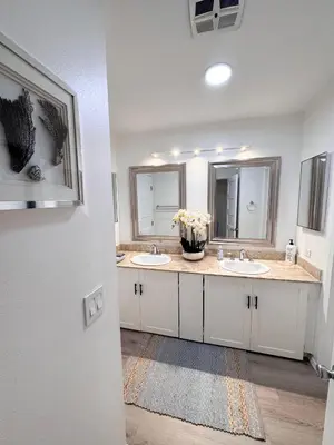 a bathroom with two sinks and two mirrors at Amazing house in La Jolla in San Diego