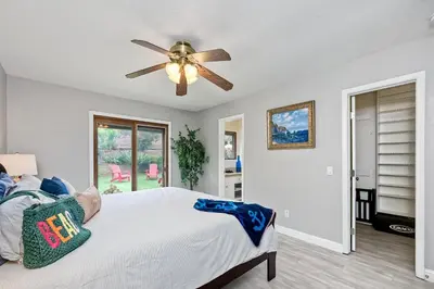 a bedroom with a bed and a ceiling fan at Carlsbad Charm - 3BR Stunner in Carlsbad