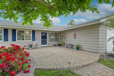 a house with a patio and flowers in front of it at Carlsbad Charm - 3BR Stunner in Carlsbad