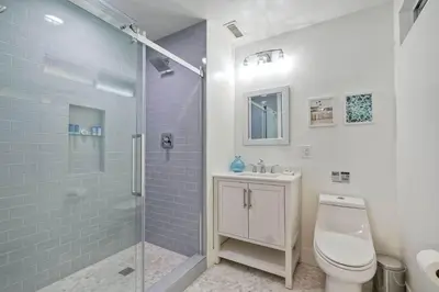 a bathroom with a toilet and a glass shower at Immaculate 3 BDR in Oceanside - Private Pool & Spa in Oceanside