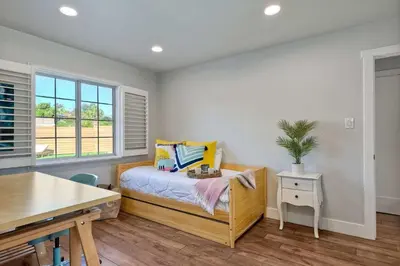 a bedroom with a bed with a desk and a table at Immaculate 3 BDR in Oceanside - Private Pool & Spa in Oceanside