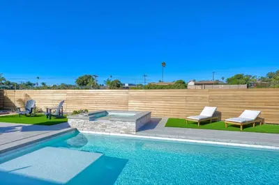 a swimming pool with two lounge chairs at Immaculate 3 BDR in Oceanside - Private Pool & Spa in Oceanside
