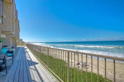 a view of the beach from the balcony of a condo at Seaside Sunset in Carlsbad