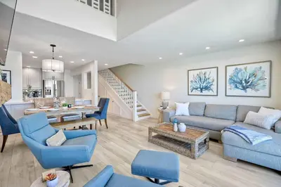 a living room with blue chairs and a couch at Seaside Sunset in Carlsbad
