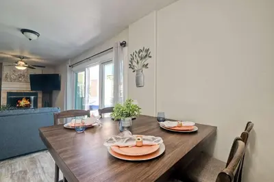 a dining room with a wooden table and chairs at Silver Surf Getaway in Oceanside