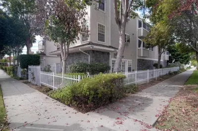 a white fence in front of a house at Silver Surf Getaway in Oceanside