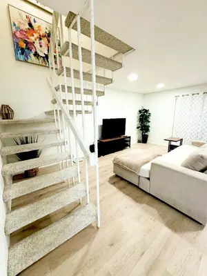 a bedroom with a bed and a spiral staircase at Amazing House in La Jolla, CA in San Diego