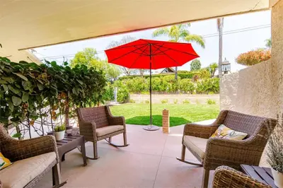 a patio with chairs and a red umbrella at Luxury View Home Perfect for SD Getaway Sleeps 12 in La Mesa