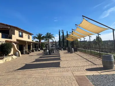 a walkway with a row of umbrellas next to a building at Casita Vino Dog-Friendly Vineyard Retreat & Stay in Escondido