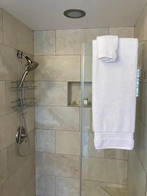 a bathroom with a shower with a white towel at Casita Vino Dog-Friendly Vineyard Retreat & Stay in Escondido