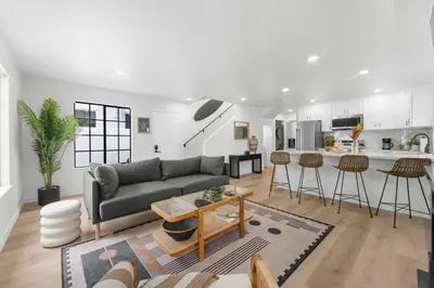 a living room with a couch and a kitchen at Walk to Mission Bay Firepit AC Putting Green in San Diego