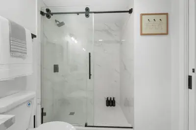 a shower with a glass door in a bathroom at Walk to Mission Bay Firepit AC Putting Green in San Diego