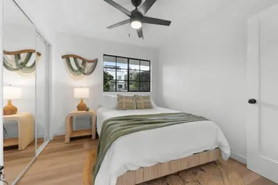 a white bedroom with a bed and a ceiling fan at Walk to Mission Bay Firepit AC Putting Green in San Diego