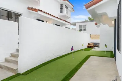a white house with a yard with green grass at Walk to Mission Bay Firepit AC Putting Green in San Diego