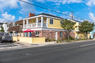 a brick house with a balcony on a street at Spacious 4Br W Oceanview Balcony, Ac, Near 40Th St Beach By Beachview Rentals in Newport Beach