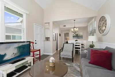 a living room with a couch and a tv at 3Br Oceanview W Prime Peninsula Location Near Beach By Beachview Rentals in Newport Beach