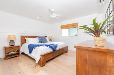 a bedroom with a bed and a ceiling fan at 3Br Luxury Condo W Rooftop Deck, Fire Pit, Steps To Sand By Beachview Rentals in Newport Beach