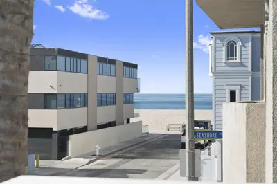 a building next to the beach with a church at Pet-Friendly 3Br W Ac, Rooftop Deck, 2 Houses From Beach By Beachview Rentals in Newport Beach