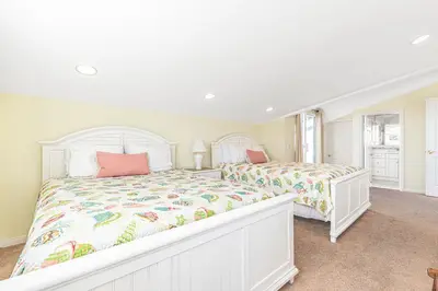 a white bedroom with two beds and a window at Family-Friendly 3Br Steps From Beach - Walk To Everything By Beachview Rentals in Newport Beach