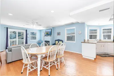 a kitchen and dining room with a table and chairs at Family-Friendly 3Br Steps From Beach - Walk To Everything By Beachview Rentals in Newport Beach