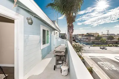 a porch with a stroller next to a house at Spacious 4Br Retreat W Rooftop Deck One Block From Beach By Beachview Rentals in Newport Beach
