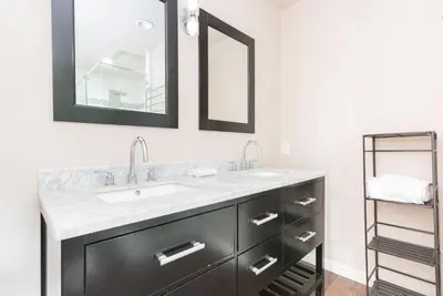 a bathroom with a sink and two mirrors at Spacious 4Br Retreat W Rooftop Deck One Block From Beach By Beachview Rentals in Newport Beach
