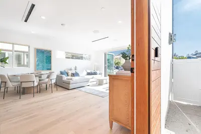 a living room with a couch and a table at Luxury 3Br W Rooftop Deck, Grill, Ac, Steps From The Sand By Beachview Rentals in Newport Beach