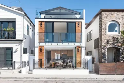 a house with a balcony in the middle of a street at Luxury 3Br W Rooftop Deck, Grill, Ac, Steps From The Sand By Beachview Rentals in Newport Beach