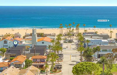 an aerial view of a beach with palm trees at Retro A-Frame Studio W Loft And Sun Deck, Steps From Sand By Beachview Rentals in Newport Beach