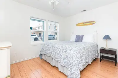 a white bedroom with a bed and a window at Charming 3Br Beach Home W Rooftop Deck One Block From Sand By Beachview Rentals in Newport Beach
